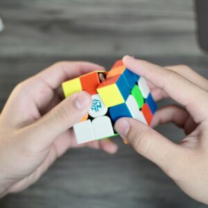 A person holding a rubik cube in their hands